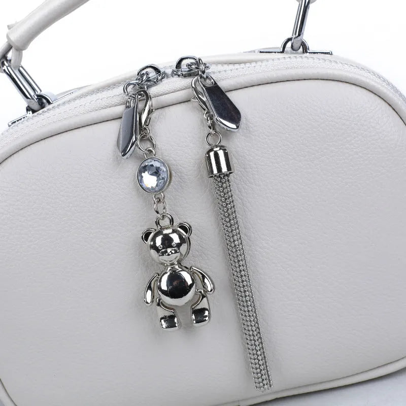 Women's small square bag with stitching detail showing oval shape and double shoulder straps