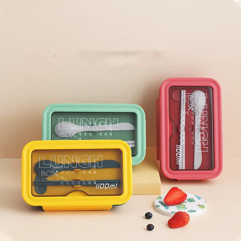 Green four-layer partitioned plastic bento box with lid, showing separate food compartments.
