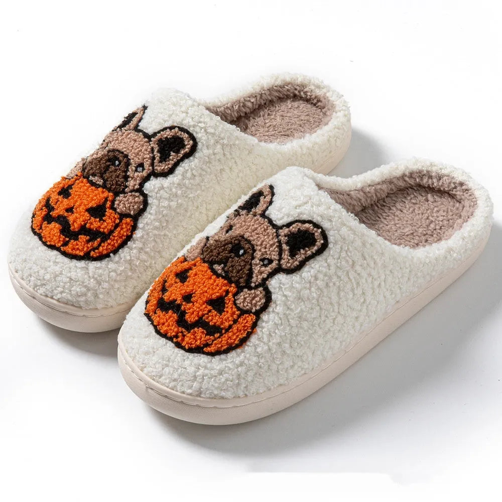 Black and white Halloween slippers with pumpkin pattern, plush upper, and textured rubber sole.