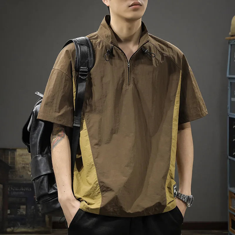 Brown men's half-zip stand collar short sleeve shirt with a fleece-lined interior on a hanger.