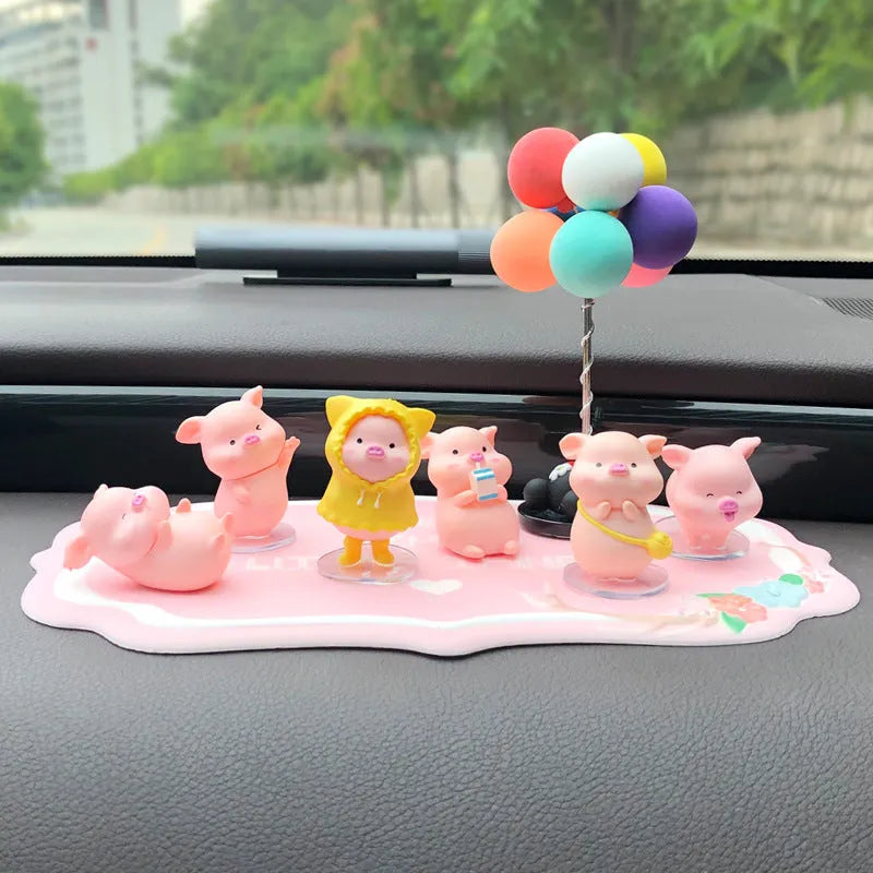 Six little pink resin pigs with colourful balloons on a rectangular anti-skid pad, cartoon car decoration