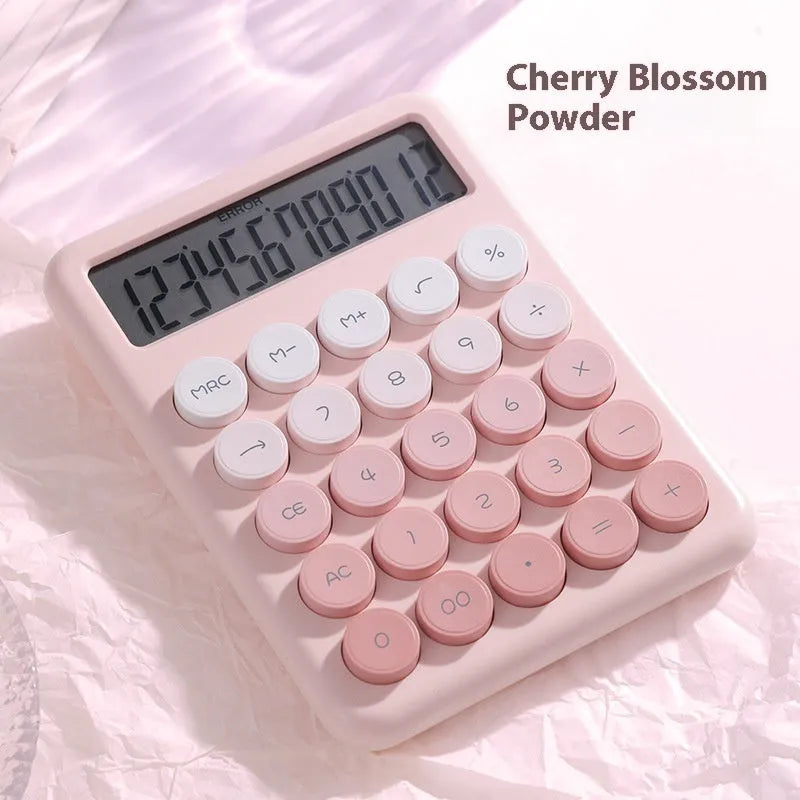 Desktop calculator with gradient colour finish in violet, cherry blossom pink, glacier blue, or mint green on a desk.