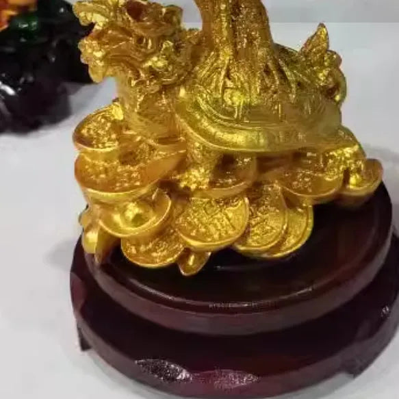 Citrine coloured small water turtle money tree resin ornament on a white background.