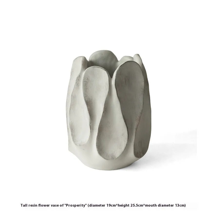 Irregular ceramic vase with resin flower device accents in magnesium clay material