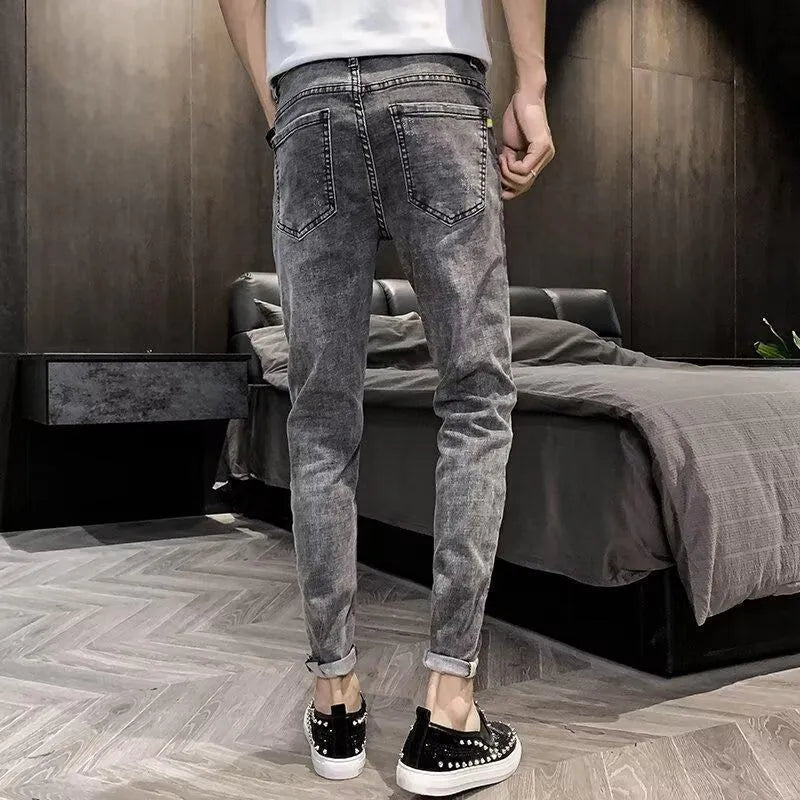 Men's classic high waist blue denim jeans with a button fly, shown laid flat.
