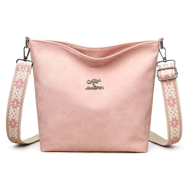 Soft grey PU crossbody bag with adjustable strap on mannequin