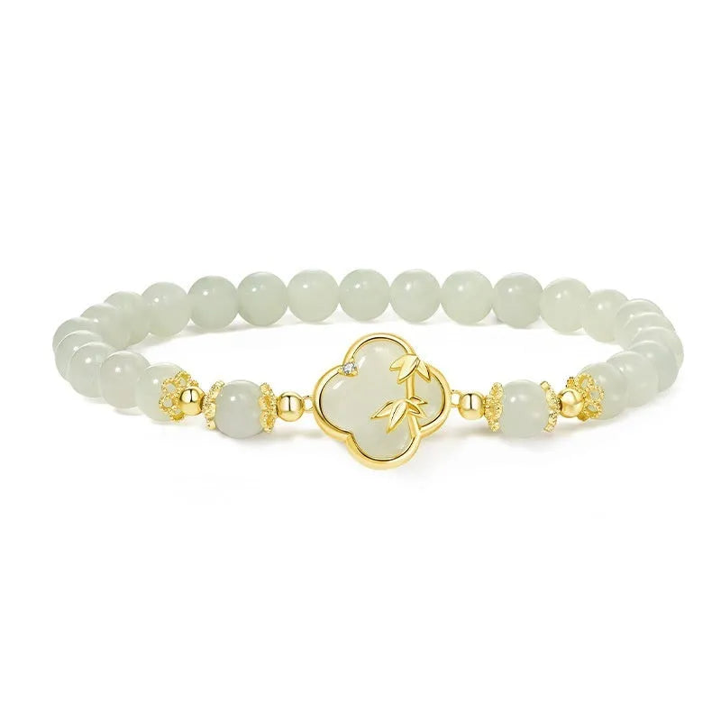Hetian Jade festival bracelet and necklace set with inlaid jade leaf designs on bamboo newspaper tone background