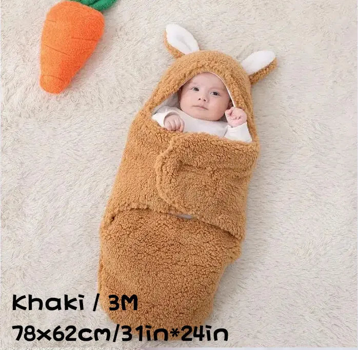 Baby wearing a grey adjustable fleece swaddle sleep sack with velcro wings