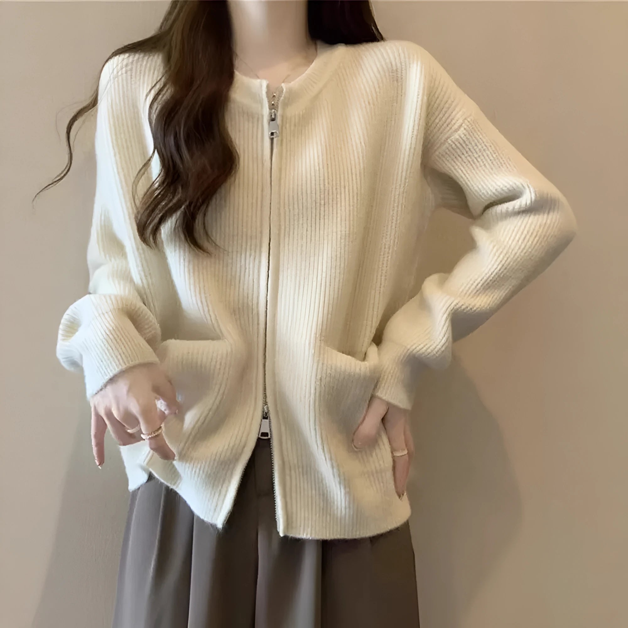 Beige viscose knit sweater coat cardigan with long sleeves laid flat.
