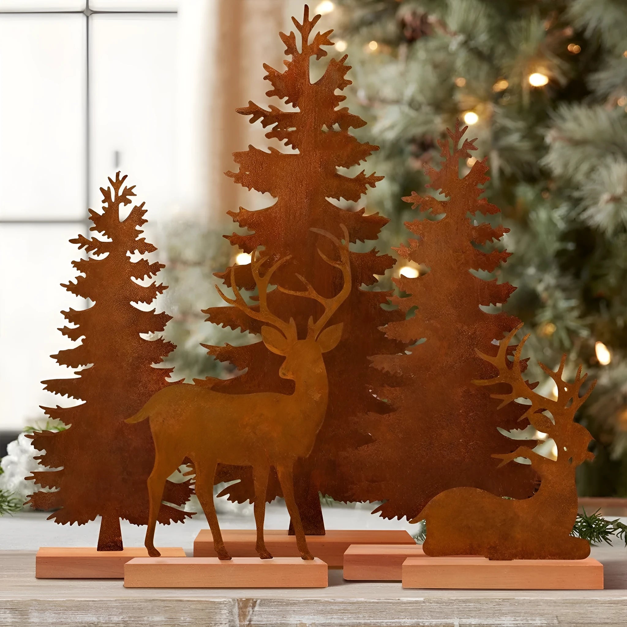 Three metal Christmas tree ornaments with rusty finish featuring elk designs