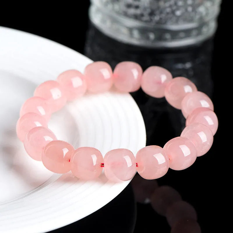Pink crystal barrel bead bracelet with 8x10mm geometry-shaped stones on wrist