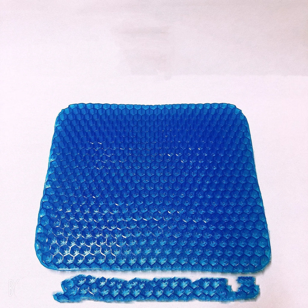A solid-colour gel seat cushion with a honeycomb pattern, shown with its removable PVC cover.