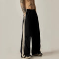 Black men's high-waist wide-leg climbing trousers laid flat, showing straight-leg design.
