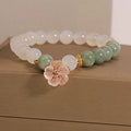 Women's floral bracelet made of white agate and jadeite stones set in jade.