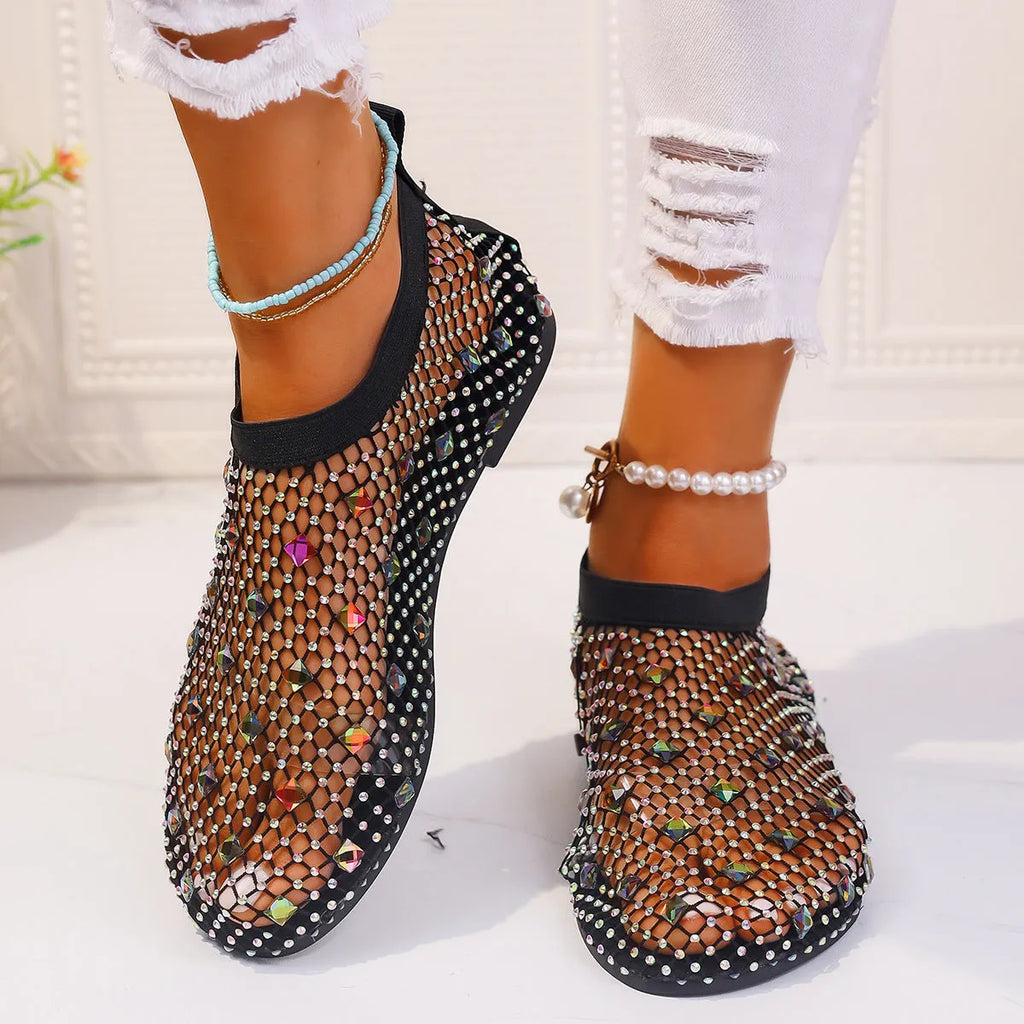 Women's flat sandals with a colourful rhinestone design on a breathable mesh upper and a rubber sole.