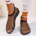Women's flat sandals with a colourful rhinestone design on a breathable mesh upper and a rubber sole.