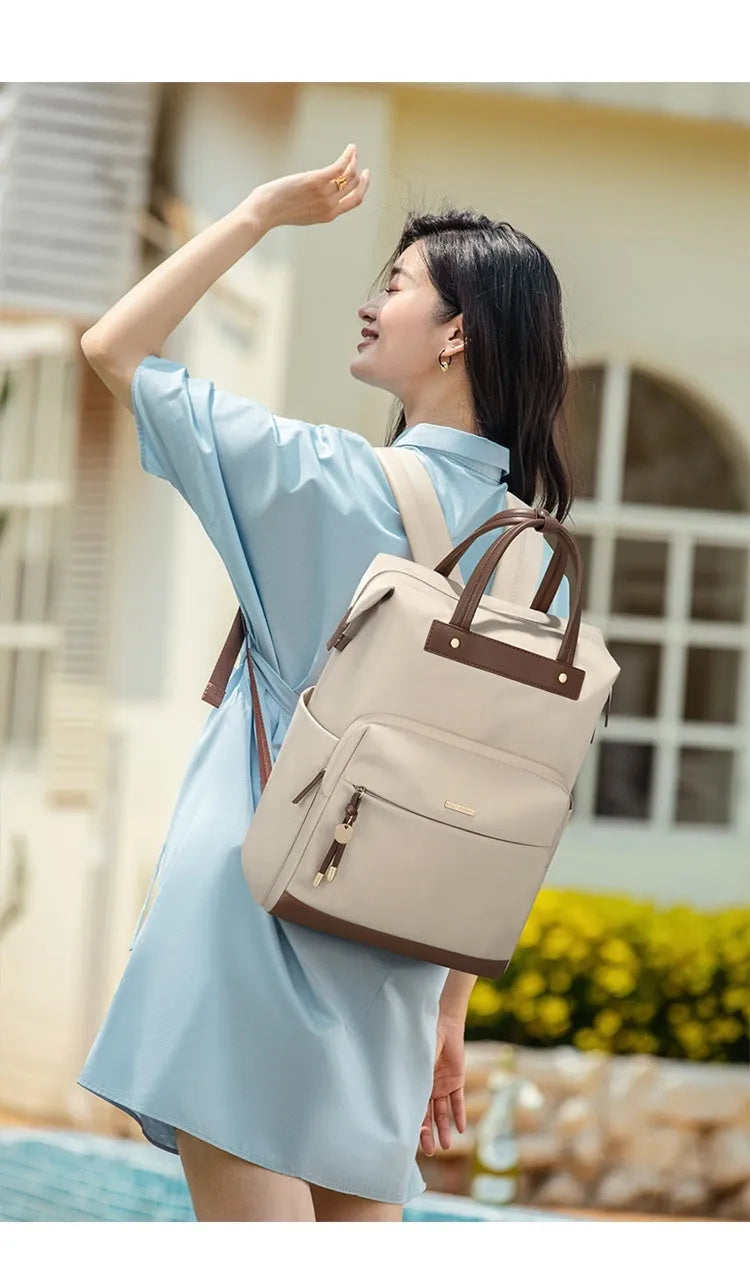 Large apricot coloured backpack with adjustable straps on a grey background