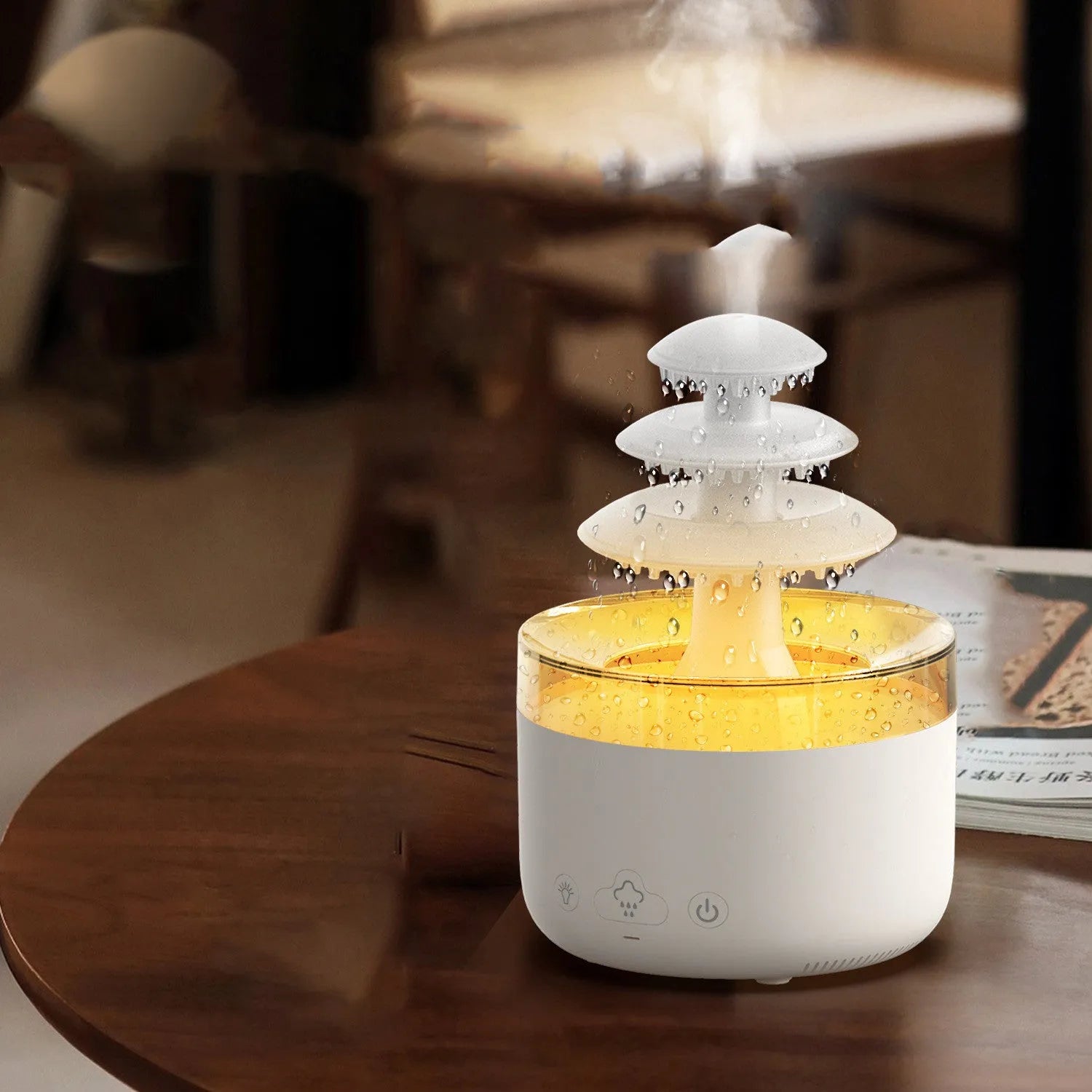 White Cloud Rain ultrasonic humidifier and essential oil diffuser with coloured LED lights on a table.