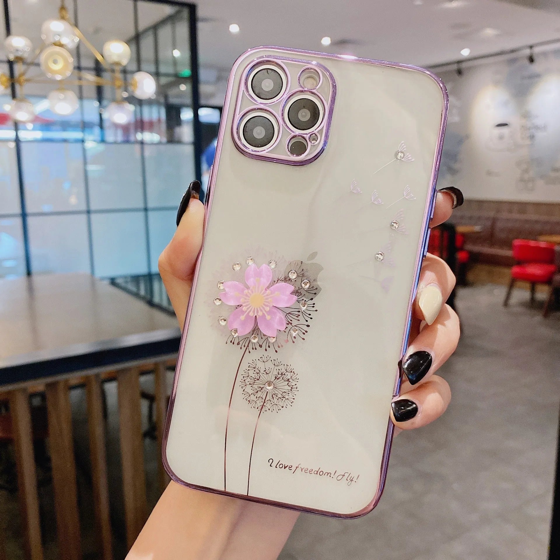 Green iPhone case with 3D white floral design and a silver rotating kickstand extended at the back.