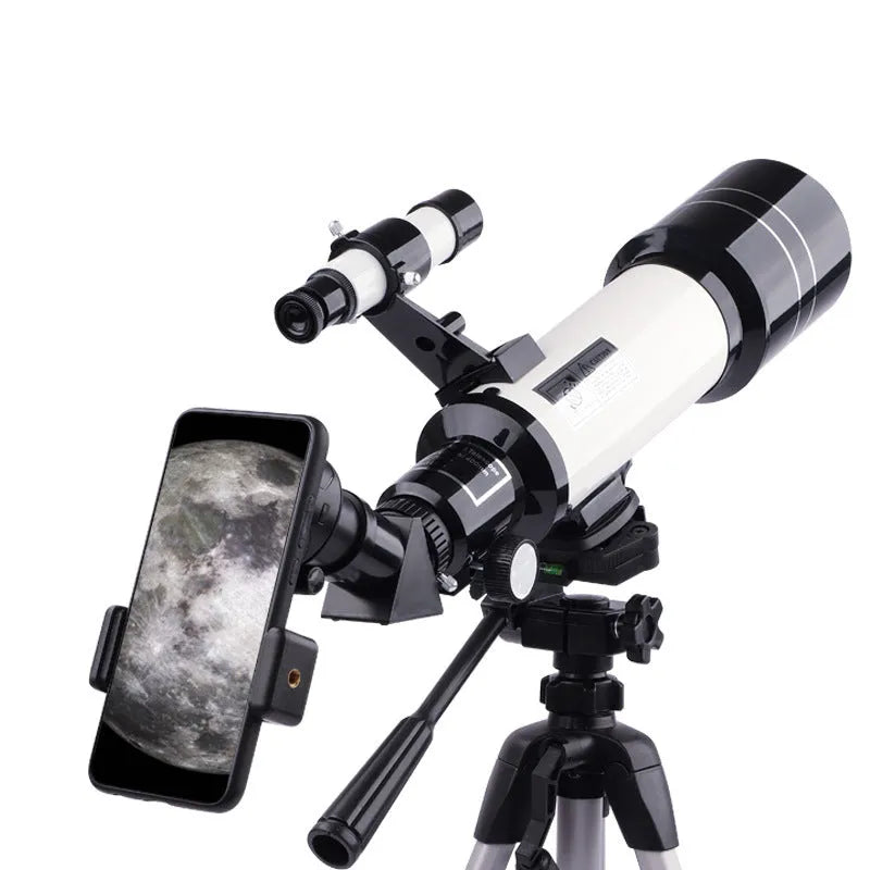 Dark blue and white children's astronomical monocular telescope on a tripod with a mobile phone holder attached.