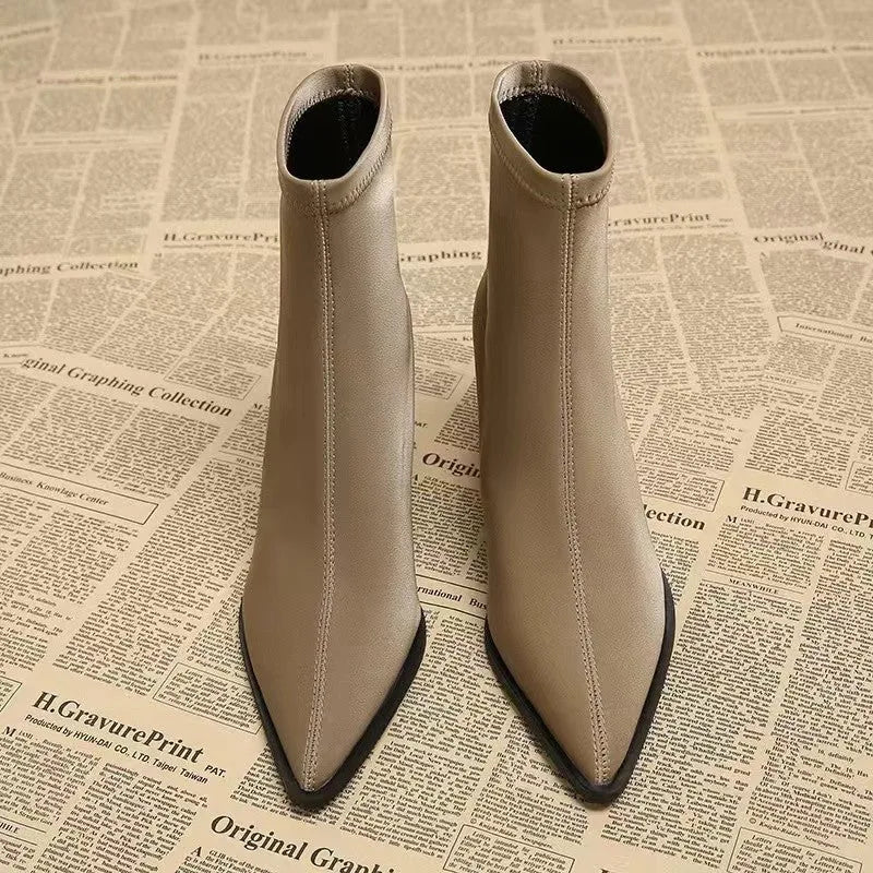 Women's khaki pointed toe fashion boots with a wedge heel on a neutral background.