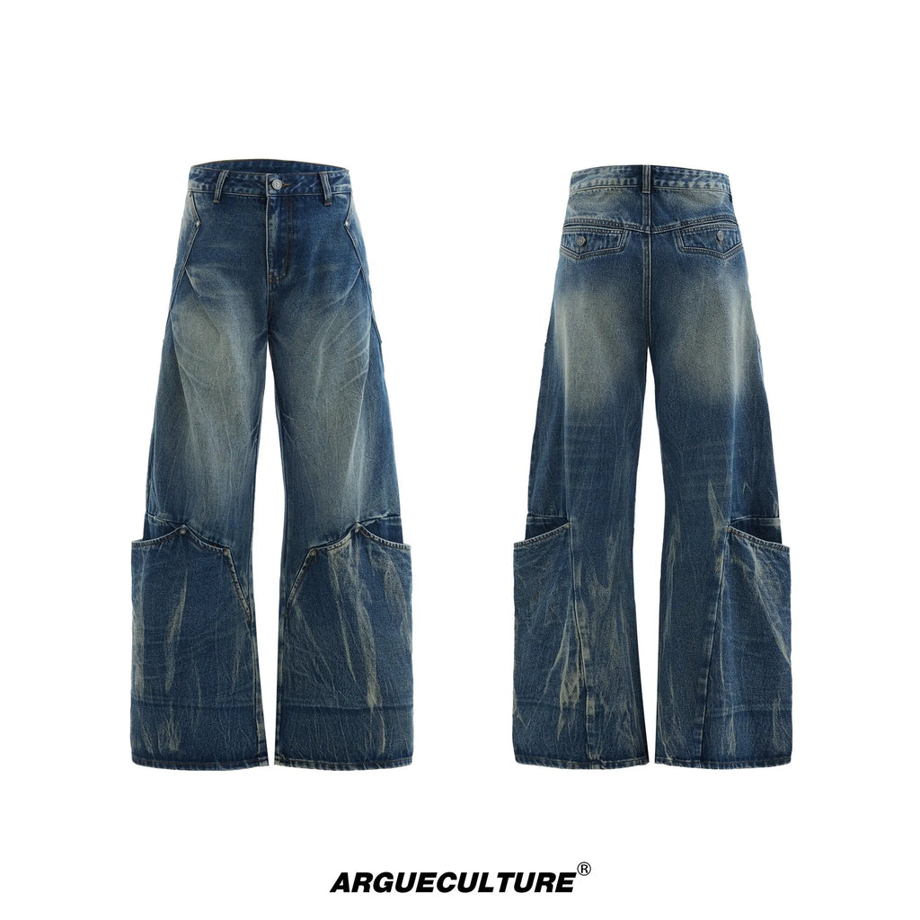 Men's verdant blue loose fit jeans showing curved knife pattern detail and vintage wash on a cotton blend fabric.