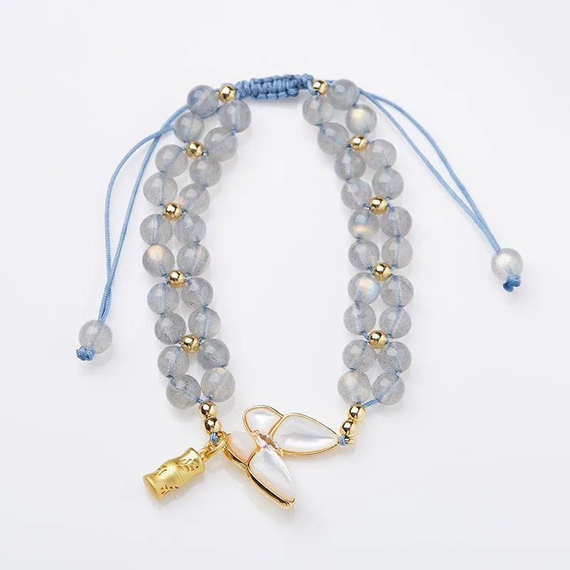 Grey moonstone woven bracelet with butterfly pattern and silver tone clasp