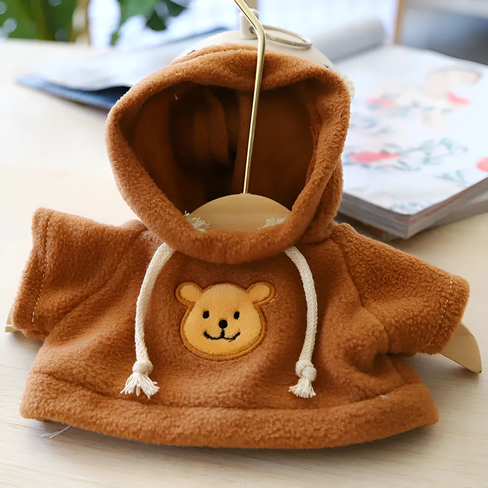 A blue cloth dog hoodie sweater shown next to a grey bear design sweater, illustrating the two available size options.