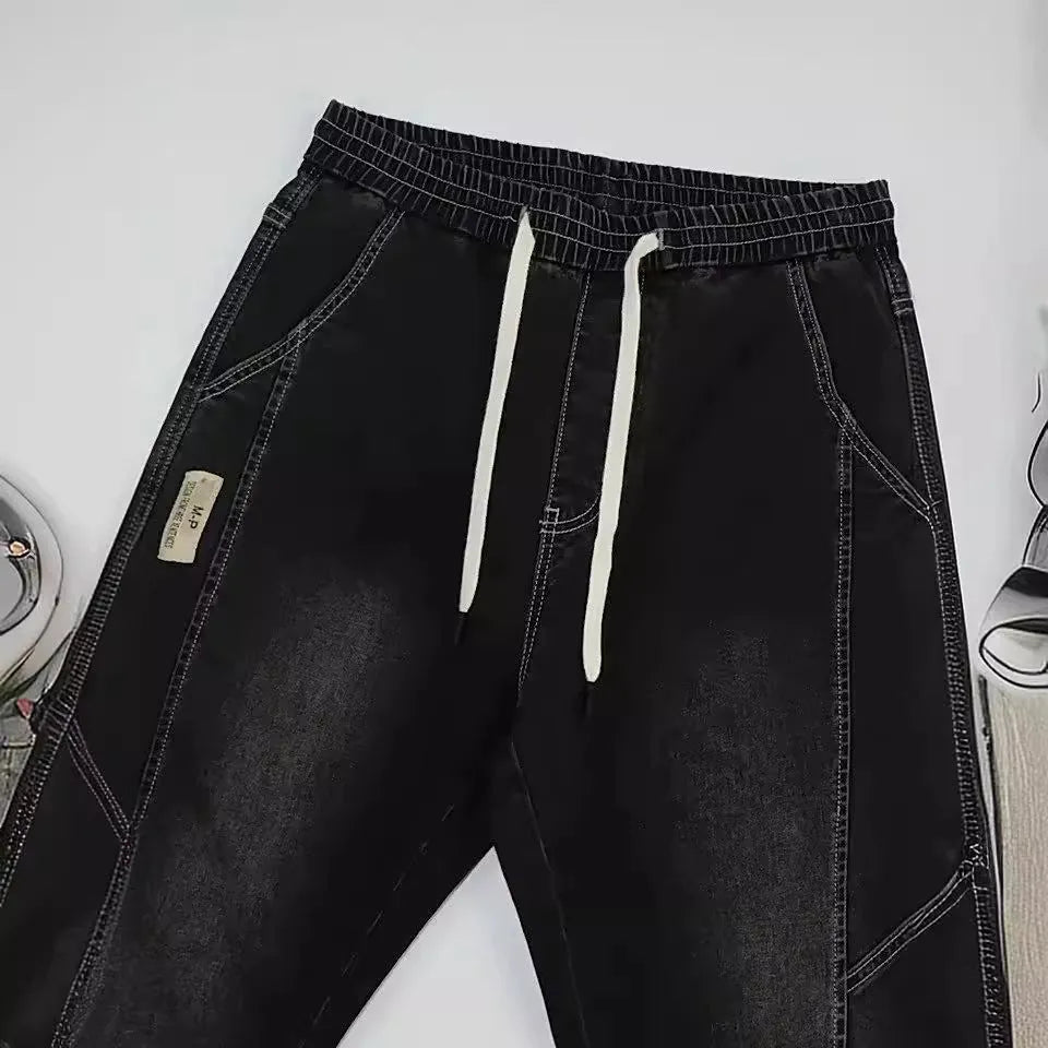 Men's slim fit straight-leg jeans in blue denim with high waist and ankle-tied style