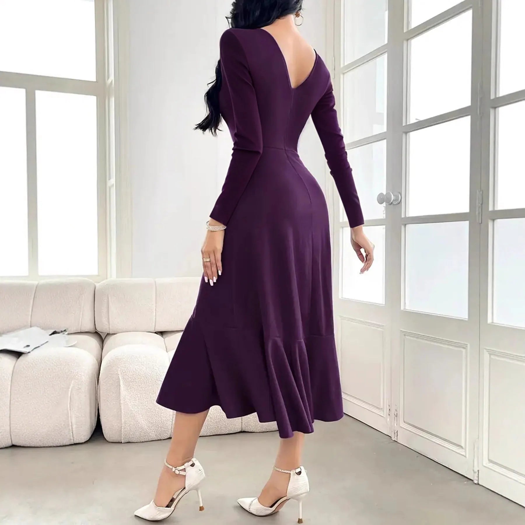 Purple women's long sleeve dress with ruffle detail and a round neck, shown on a model.