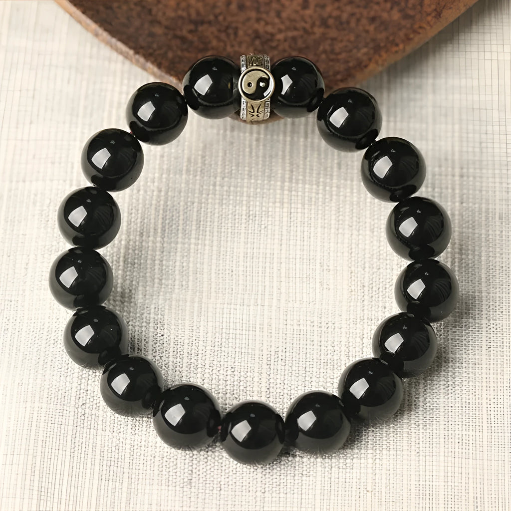 Black stone single ring bracelet for men and women on a wrist, showing 10mm and 12mm size options.