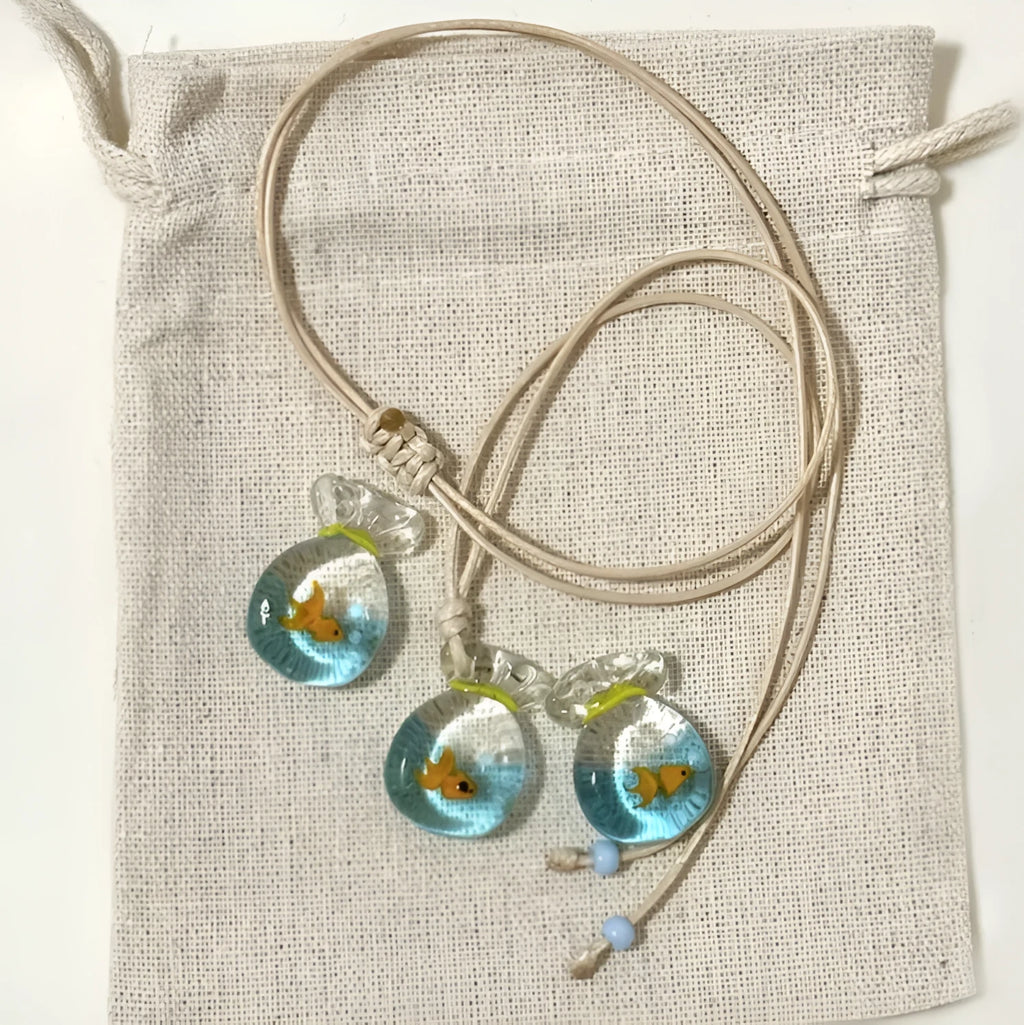 Women's joker motif pendant necklace on a braided cotton and linen clavicle chain.