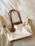 Women's pink Oxford cloth large capacity shoulder tote bag with a phone pocket.