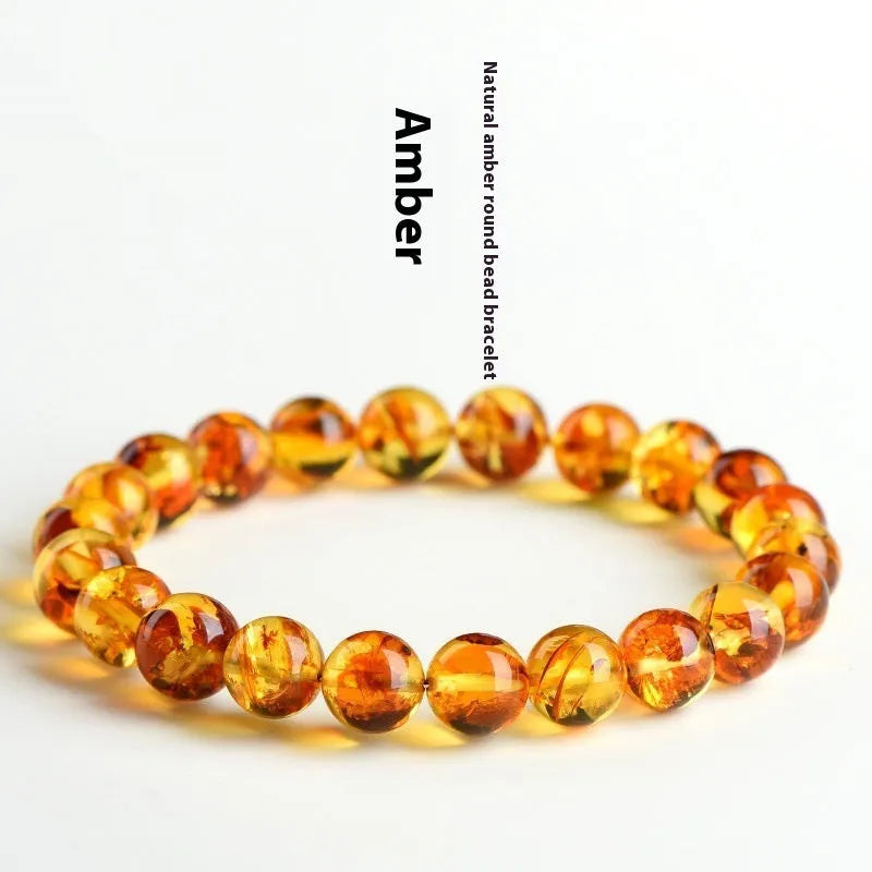Natural yellow piebald amber bracelet with geometric design on a wrist.