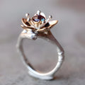Silver two-tone alloy ring with geometric floral pattern on a simple band.