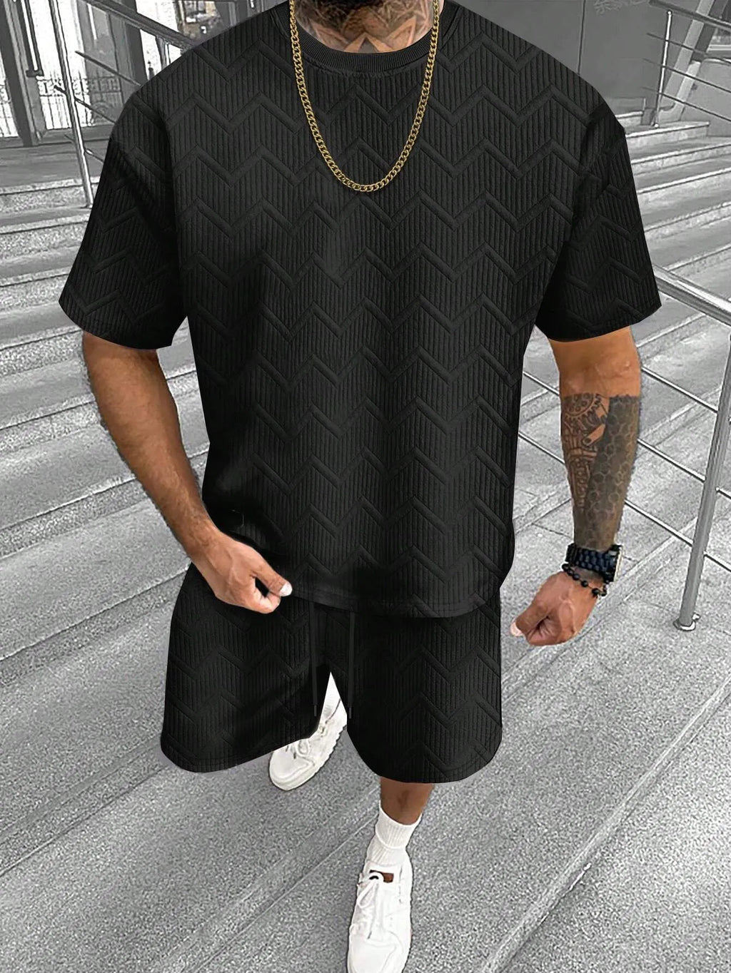 Men's printed short sleeve top and matching shorts leisure suit set on a hanger.
