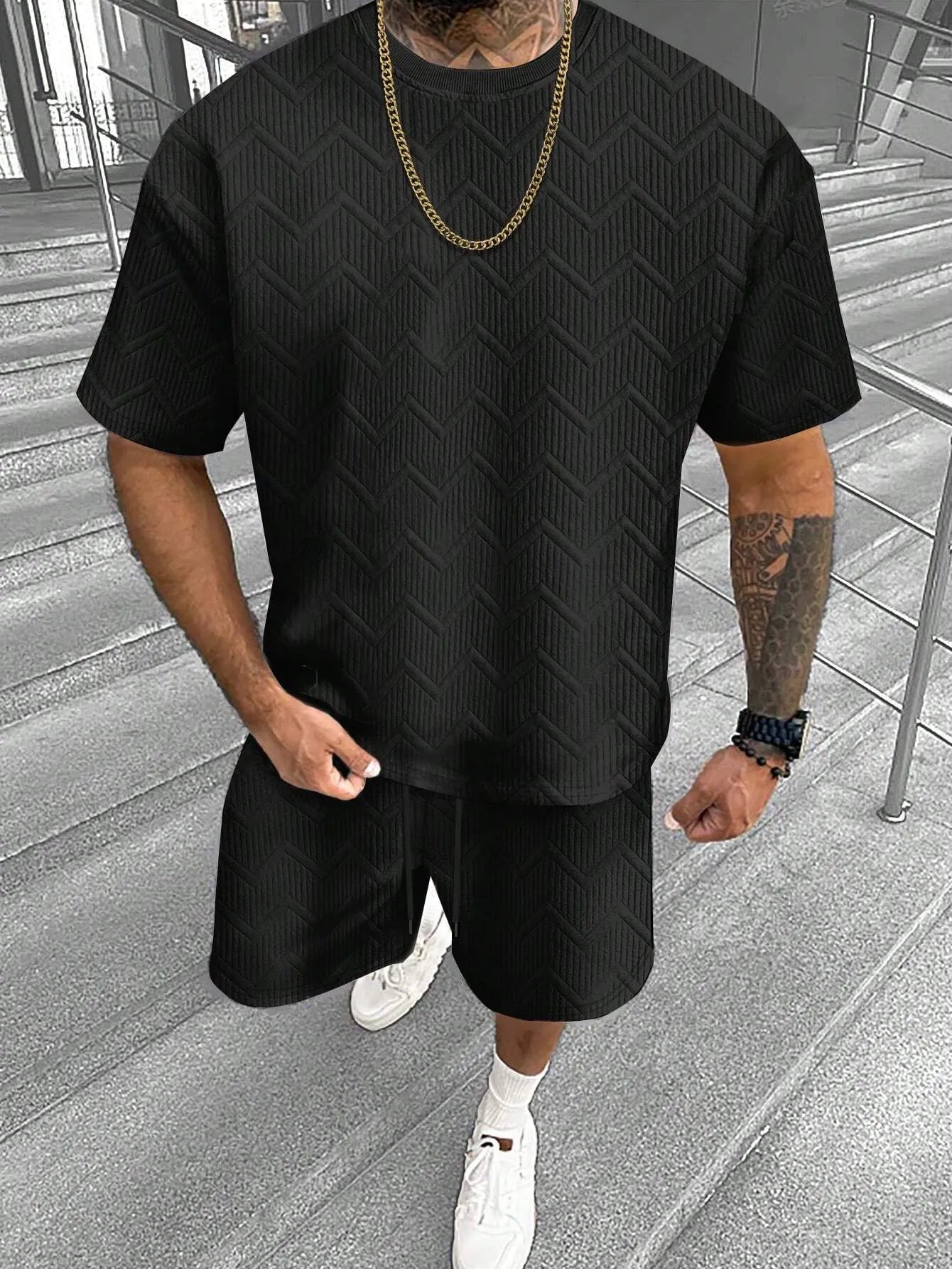 Men's printed short sleeve top and matching shorts leisure suit set on a hanger.