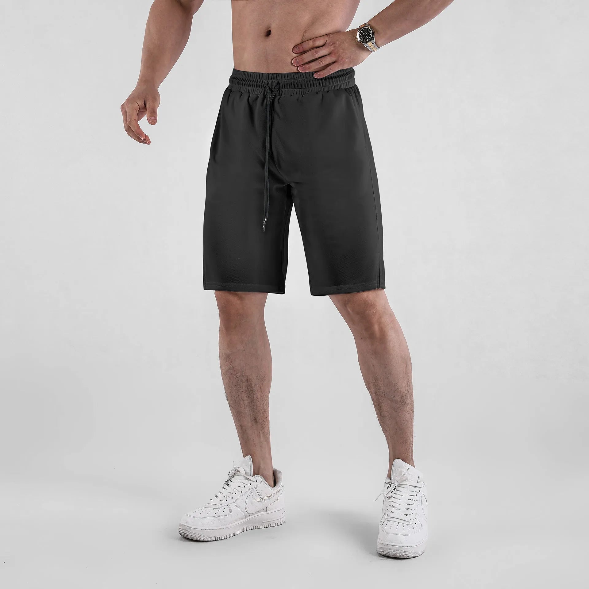 Men's black loose-fit quick-drying mesh casual shorts on a white background.
