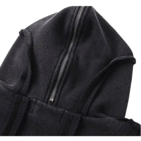 Man wearing a black loose-fit retro zip hooded coat with an abstract pattern.