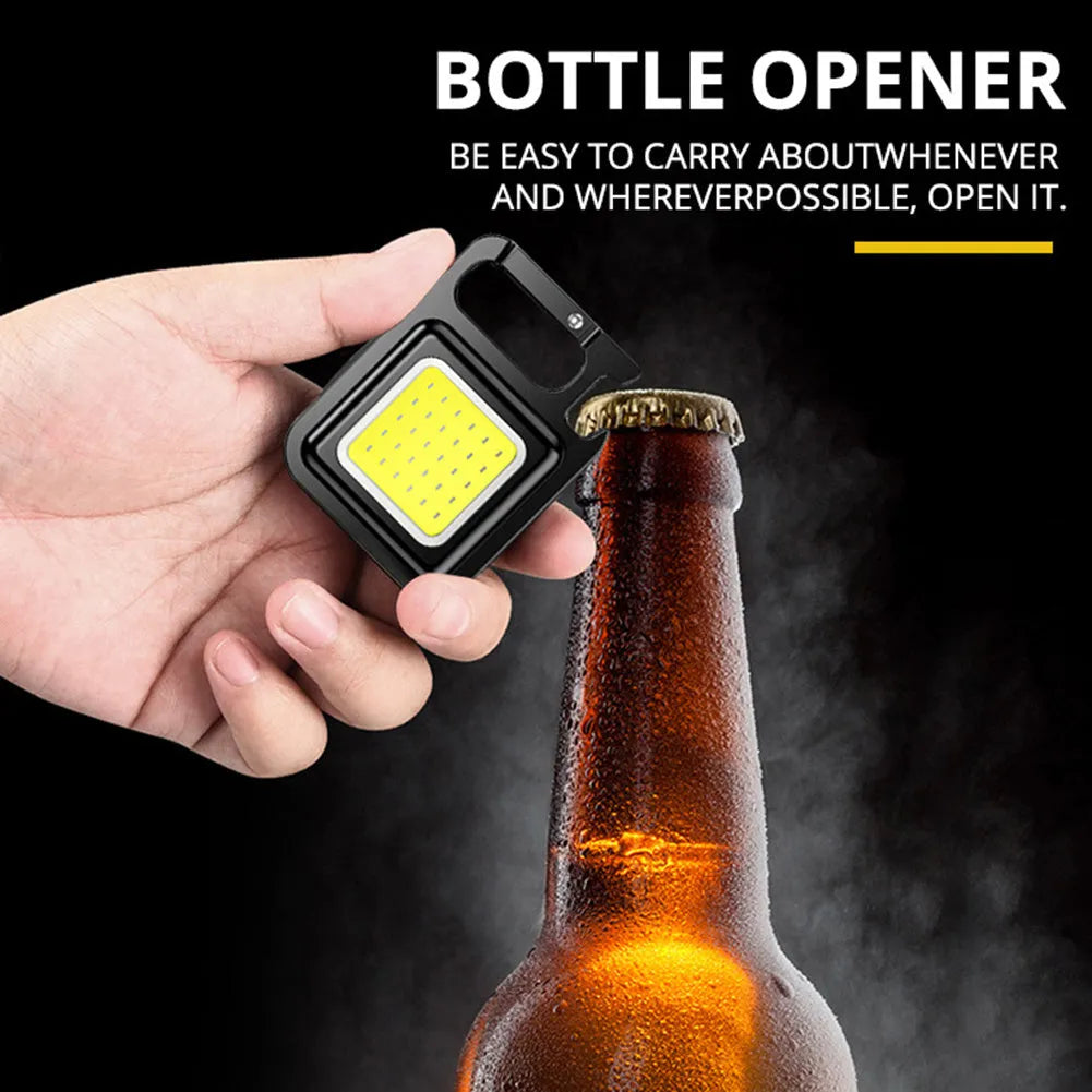Mini portable COB keychain flashlight with USB recharge, 400 lumens, and built-in bottle opener