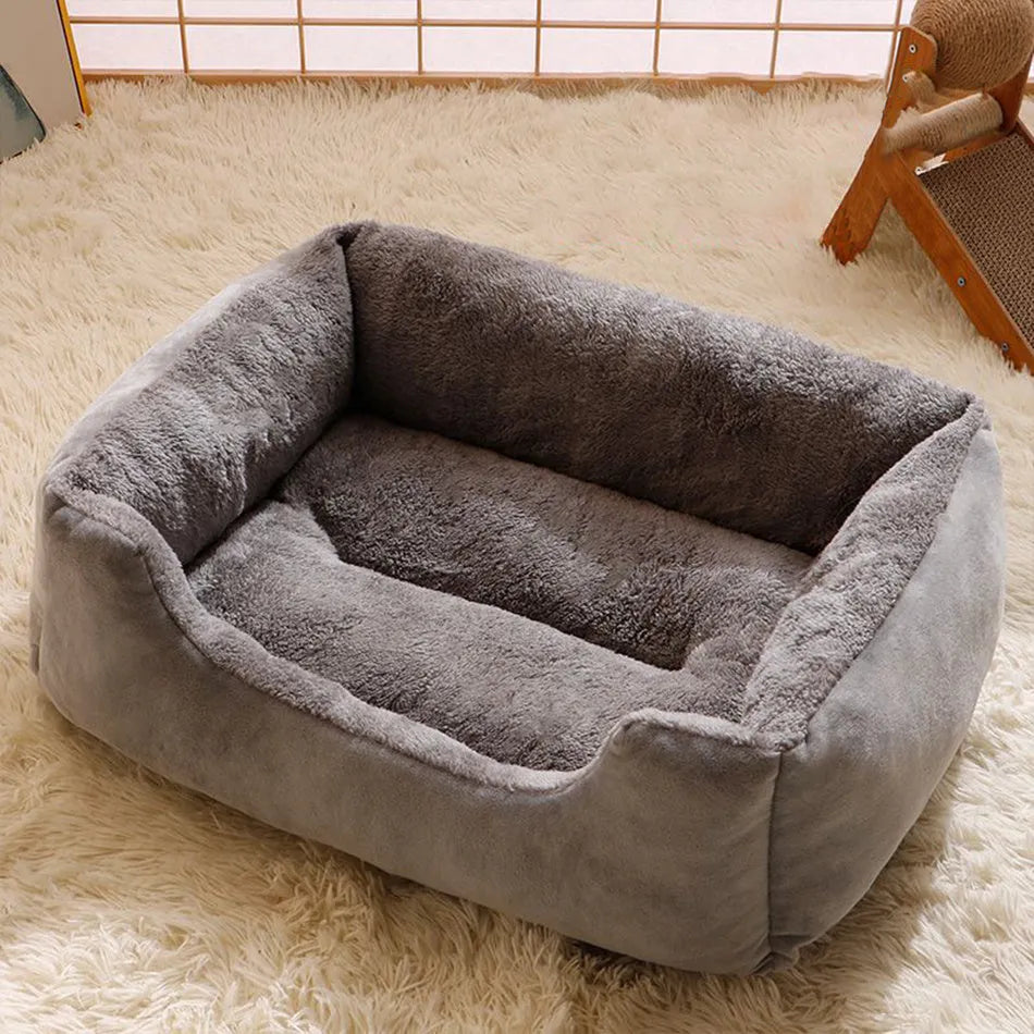 Soft short plush pet bed for cats and dogs in grey, shown in a large size on a wooden floor.