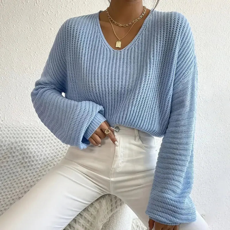 A woman's solid colour long sleeve pullover jumper in a loose, casual fit.