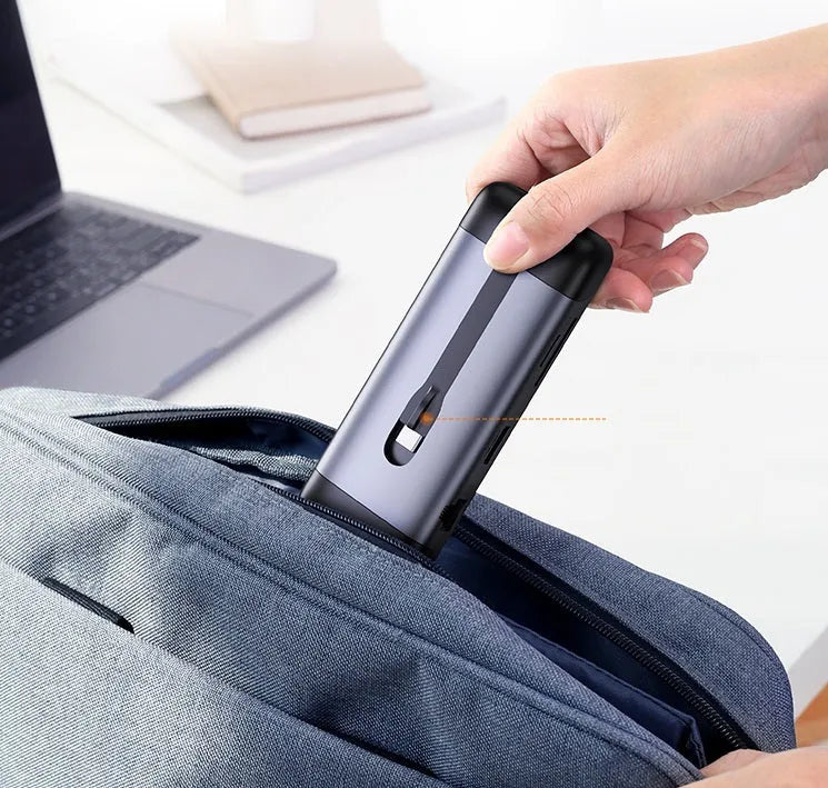 Compact 9-in-1 USB dock adapter with HDMI, VGA, Ethernet, USB 3.0, and card reader ports.