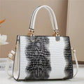 Soft PU leather one shoulder mum bag in a horizontal square shape, shown in a neutral colour with visible internal zip pockets.