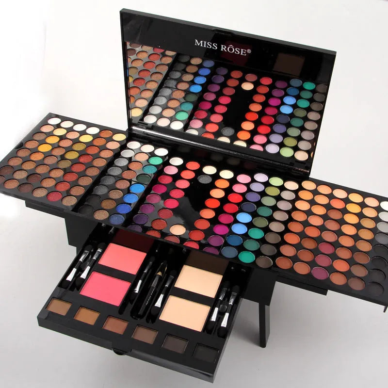 Piano-shaped makeup palette showing 180 colour eyeshadows, blushes, and powders in organised layout