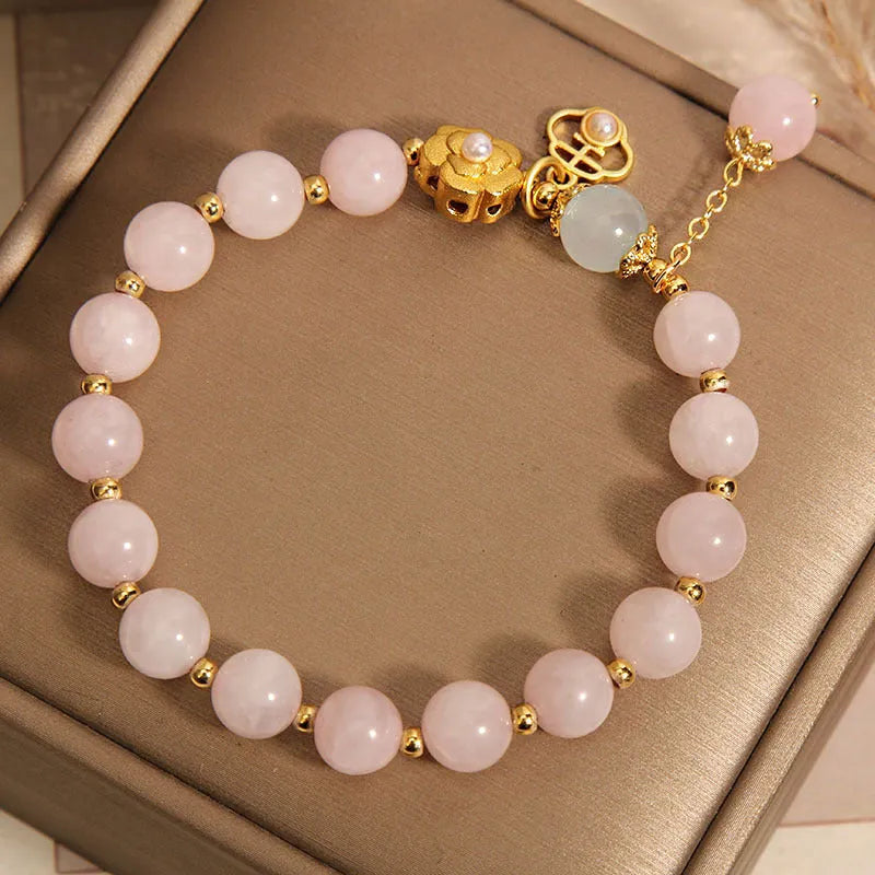 Women's pink crystal flower charm bracelet with delicate floral design