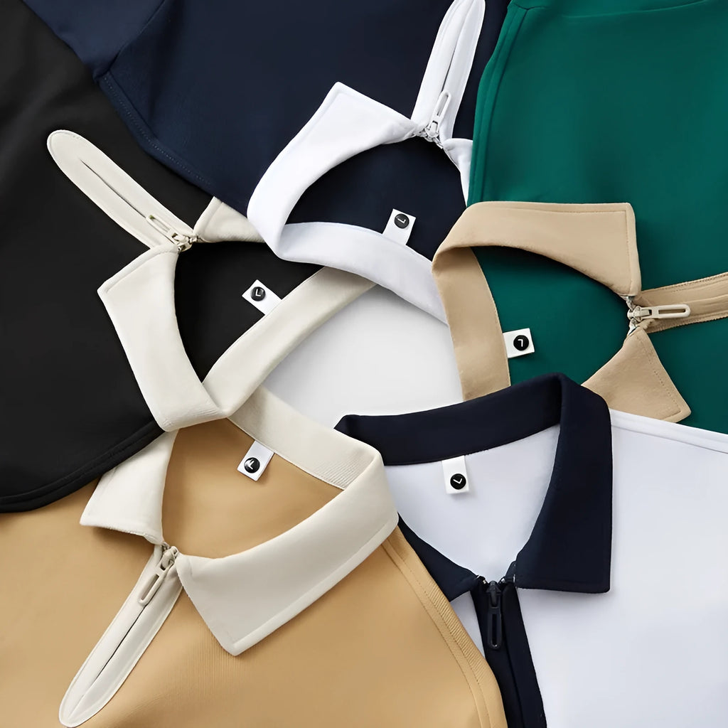 Man's solid colour polo shirt with a front zipper and lapel collar, shown in a loose fit.