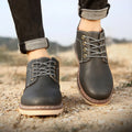 Men's black mid-top waterproof boots with rubber soles and PU leather uppers on a white background.
