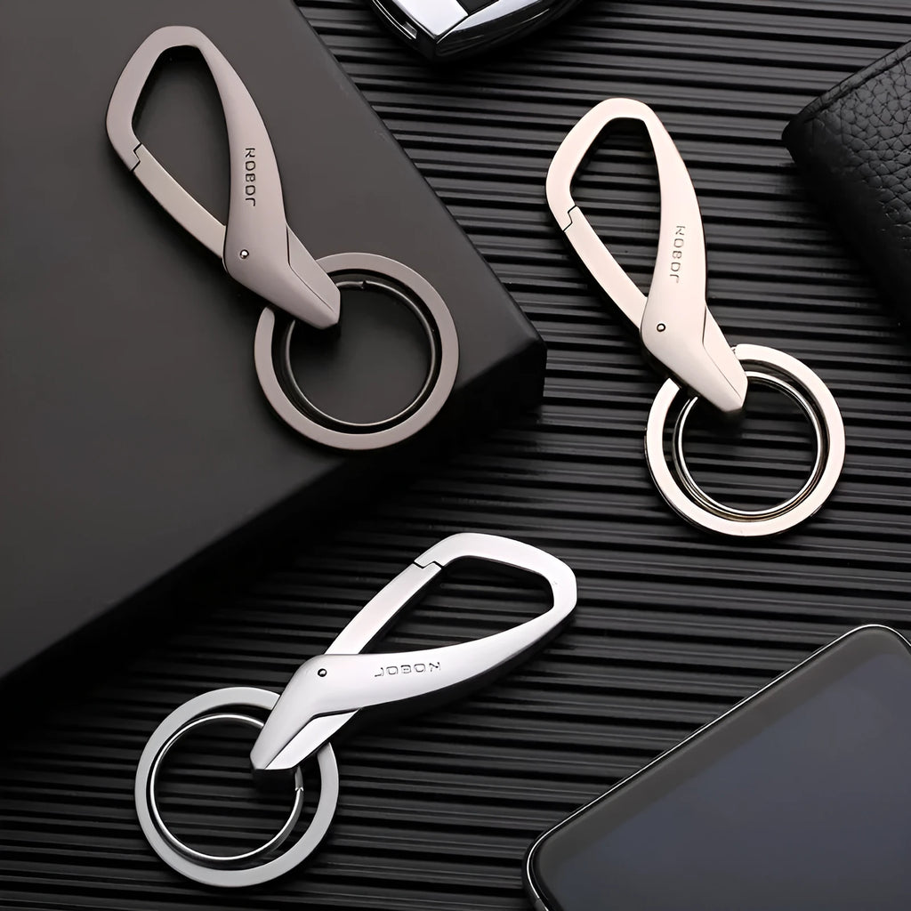 Black zinc alloy double ring key chain on a table, showing its 8.3cm length and compact design.