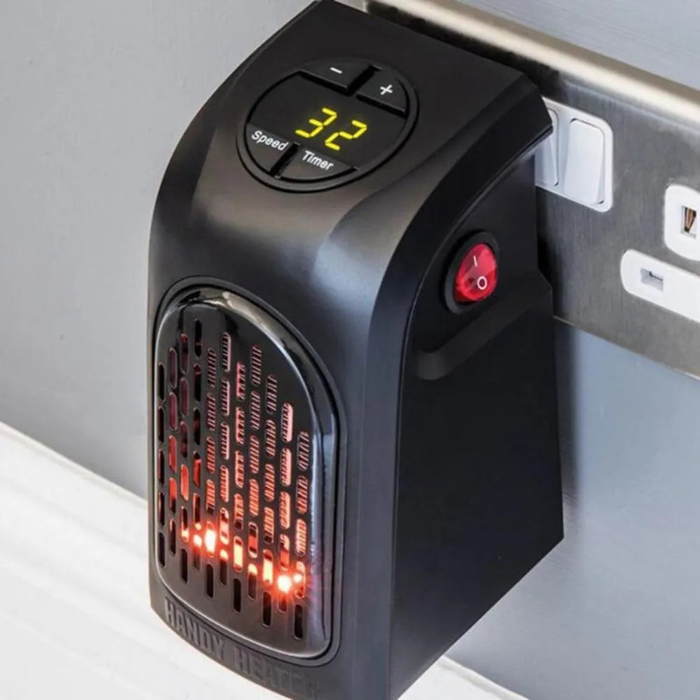 Small black ceramic fan heater on a table showing control buttons and compact size.